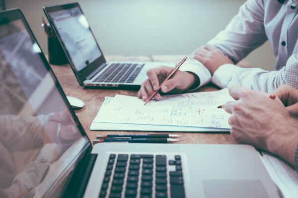Business people reviewing insurance and financial paperwork